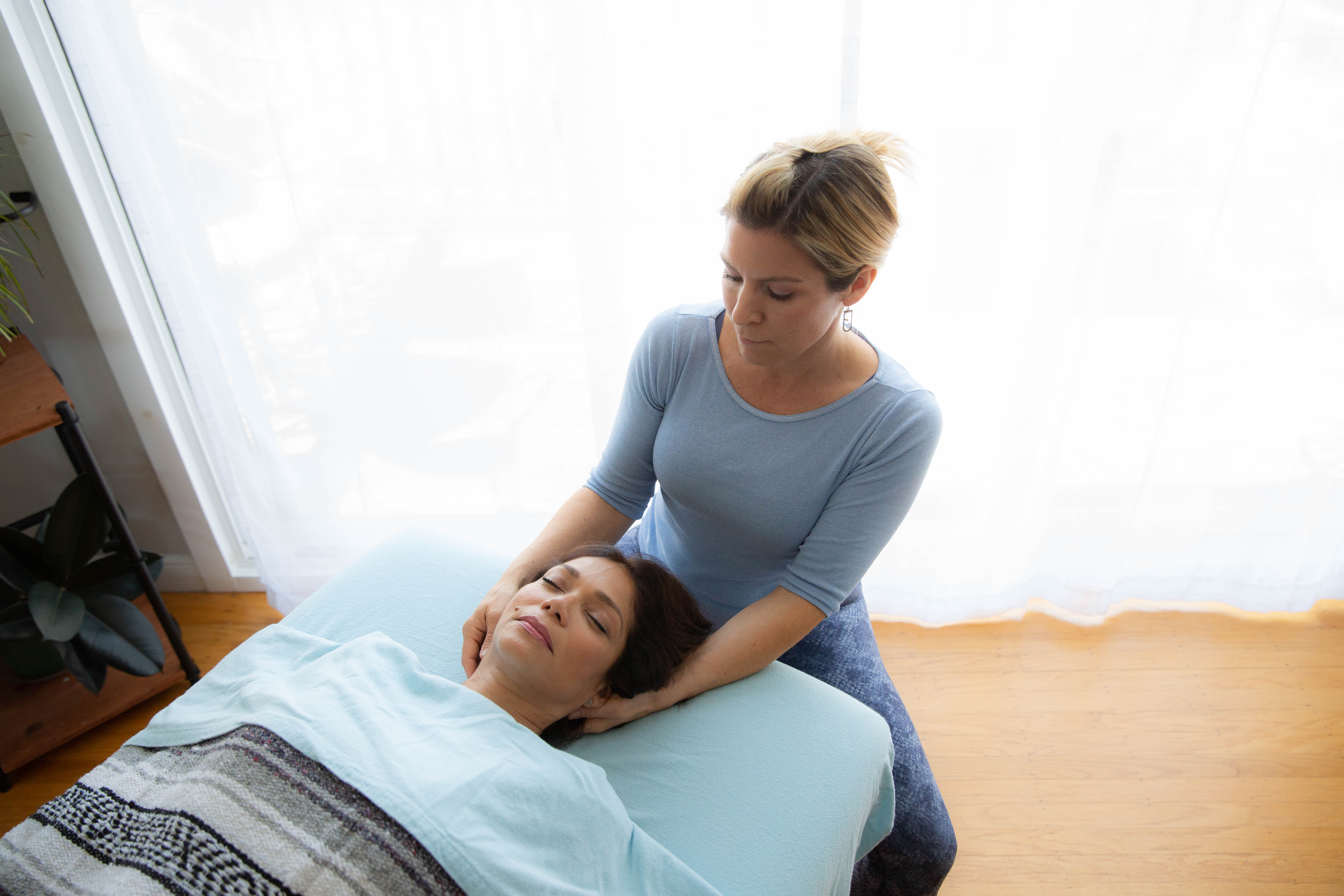 Megan Gathers giving a neck massage.