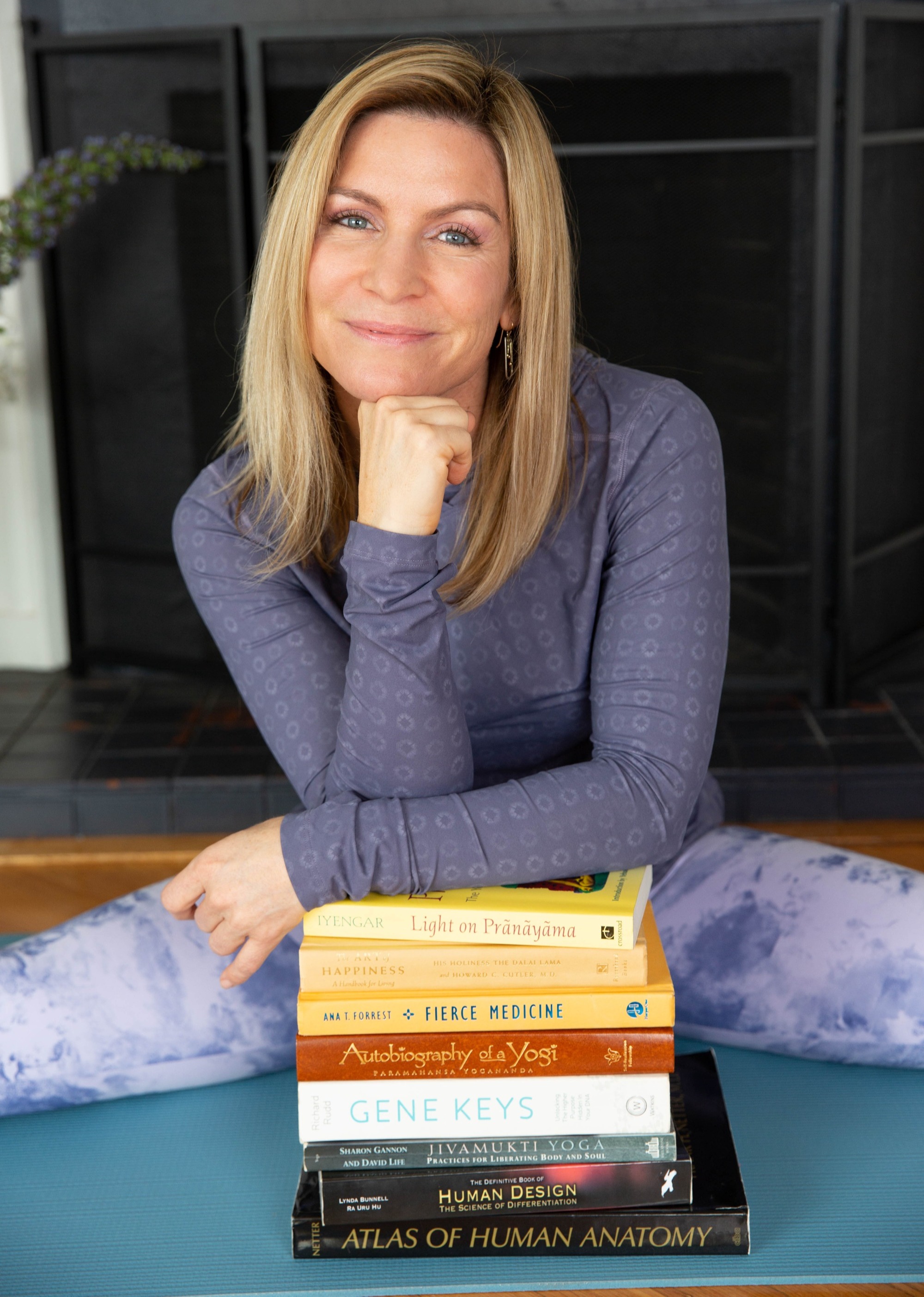 Megan Gathers with a stack of books.